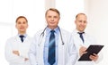 Group of smiling male doctors in white coats