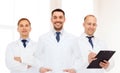 Group of smiling male doctors in white coats