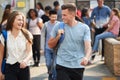 Group Of Smiling Male And Female College Students Walking And Chatting Outside School Building Royalty Free Stock Photo