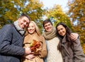 Group of smiling men and women in autumn park Royalty Free Stock Photo