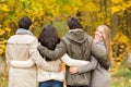 Group of smiling men and women in autumn park Royalty Free Stock Photo