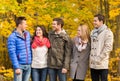 Group of smiling men and women in autumn park Royalty Free Stock Photo