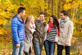 Group of smiling men and women in autumn park Royalty Free Stock Photo