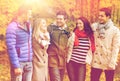 Group of smiling men and women in autumn park Royalty Free Stock Photo