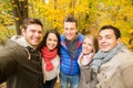 Group of smiling men and women in autumn park Royalty Free Stock Photo