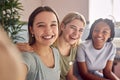 Group Of Smiling Multi-Cultural Teenage Girl Friends Posing For Selfie On Mobile Phone At Home Royalty Free Stock Photo