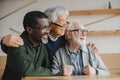 Senior friends embracing and looking away Royalty Free Stock Photo
