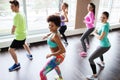 Group of smiling people dancing in gym or studio Royalty Free Stock Photo