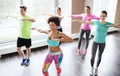 Group of smiling people dancing in gym or studio Royalty Free Stock Photo