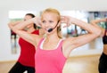 Group of smiling people exercising in the gym Royalty Free Stock Photo