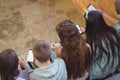 Group of smiling school friends sitting on staircase using mobile phone Royalty Free Stock Photo