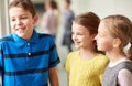 Group of smiling school kids talking in corridor Royalty Free Stock Photo