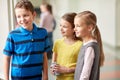 Group of smiling school kids talking in corridor Royalty Free Stock Photo