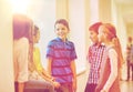 Group of smiling school kids talking in corridor Royalty Free Stock Photo