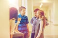 Group of smiling school kids talking in corridor Royalty Free Stock Photo