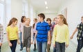 Group of smiling school kids walking in corridor Royalty Free Stock Photo