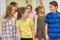 Group of smiling school kids walking in corridor Royalty Free Stock Photo
