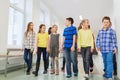 Group of smiling school kids walking in corridor Royalty Free Stock Photo