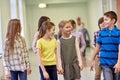 Group of smiling school kids walking in corridor Royalty Free Stock Photo
