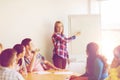 Group of smiling students with flip board