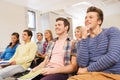 Group of smiling students in lecture hall Royalty Free Stock Photo