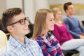 Group of smiling students in lecture hall Royalty Free Stock Photo