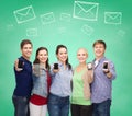 Group of smiling students showing smartphones