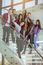 Group of smiling students with smartphone taking selfie Royalty Free Stock Photo