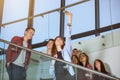 Group of smiling students with smartphone taking selfie Royalty Free Stock Photo