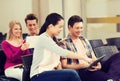 Group of smiling students with tablet pc