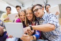 Group of smiling students with tablet pc