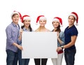 Group of smiling students with white blank board Royalty Free Stock Photo