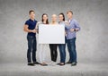 Group of smiling students with white blank board Royalty Free Stock Photo