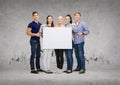 Group of smiling students with white blank board Royalty Free Stock Photo