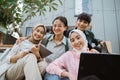 group of smiling students working together using a laptop Royalty Free Stock Photo