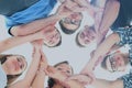 Group of smiling teenagers with hands on top of each other Royalty Free Stock Photo