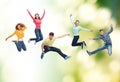 Group of smiling teenagers jumping in air Royalty Free Stock Photo