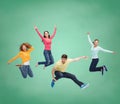 Group of smiling teenagers jumping in air Royalty Free Stock Photo