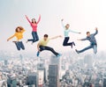 Group of smiling teenagers jumping in air Royalty Free Stock Photo