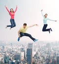 Group of smiling teenagers jumping in air Royalty Free Stock Photo