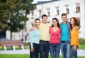Group of smiling teenagers over campus background Royalty Free Stock Photo