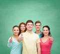 Group of smiling teenagers over green board Royalty Free Stock Photo