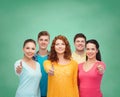 Group of smiling teenagers over green board Royalty Free Stock Photo