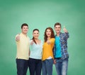 Group of smiling teenagers over green board Royalty Free Stock Photo