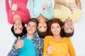 Group of smiling teenagers showing thumbs up Royalty Free Stock Photo