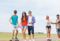 Group of smiling teenagers with skateboards