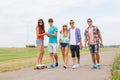 Group of smiling teenagers with skateboards