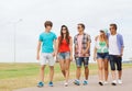 Group of smiling teenagers walking outdoors