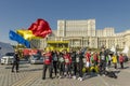 Group smiling and waving Romanian flag