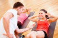 Group of smiling women doing sit ups in the gym Royalty Free Stock Photo